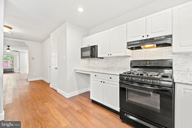 41 Bellevue Ter, Collingswood, NJ 08108 - kitchen featuring range with gas stovetop, under cabinet range hood, black microwave, backsplash, and white cabinetry