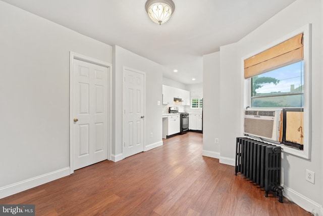 41 Bellevue Ter, Collingswood, NJ 08108 - unfurnished living room featuring radiator, wood finished floors, recessed lighting, and cooling unit