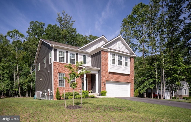 610 Long Meadow Dr, Fredericksburg, VA 22406 - view of front of house featuring a garage, asphalt driveway, a front lawn, brick siding, and central AC