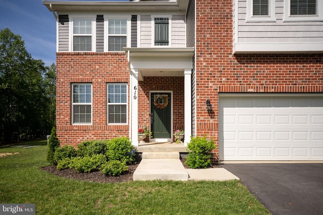 610 Long Meadow Dr, Fredericksburg, VA 22406 - view of front of home with brick siding, a garage, a front lawn, and driveway
