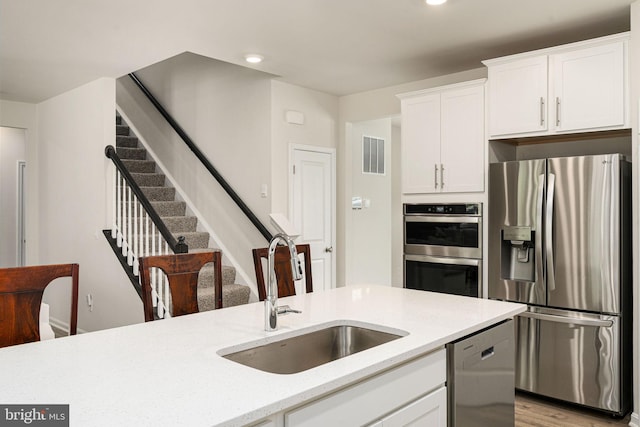 610 Long Meadow Dr, Fredericksburg, VA 22406 - kitchen with appliances with stainless steel finishes, a sink, white cabinets, light stone countertops, and recessed lighting