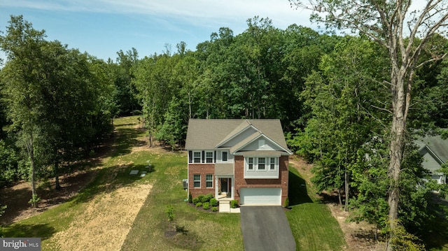 610 Long Meadow Dr, Fredericksburg, VA 22406 - view of front of property with asphalt driveway, an attached garage, brick siding, a front yard, and a wooded view