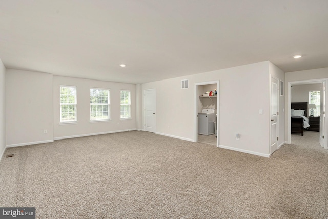 610 Long Meadow Dr, Fredericksburg, VA 22406 - unfurnished living room featuring light carpet, baseboards, healthy amount of natural light, washer / dryer, and recessed lighting
