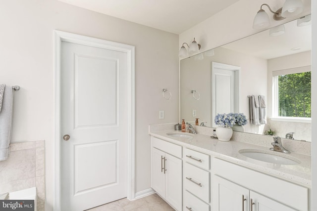 610 Long Meadow Dr, Fredericksburg, VA 22406 - bathroom featuring double vanity, a tub to relax in, and tile patterned flooring
