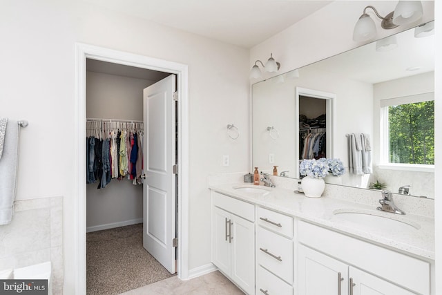 610 Long Meadow Dr, Fredericksburg, VA 22406 - full bathroom featuring double vanity, a walk in closet, a bathtub, and baseboards