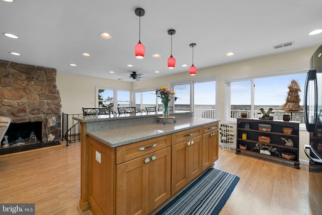 295 Chesapeake Ave, Prince Frederick, MD 20678 - kitchen with ceiling fan, light wood-type flooring, hanging light fixtures, light stone countertops, and recessed lighting