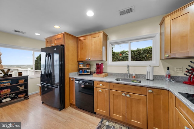 295 Chesapeake Ave, Prince Frederick, MD 20678 - kitchen featuring black appliances, a sink, light wood-style floors, recessed lighting, and brown cabinets