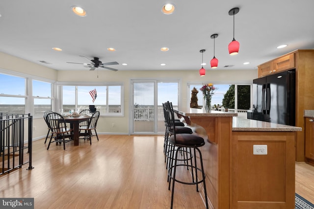 295 Chesapeake Ave, Prince Frederick, MD 20678 - kitchen featuring freestanding refrigerator, baseboards, a kitchen island, healthy amount of natural light, and recessed lighting
