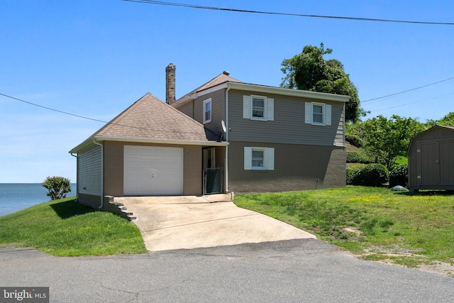 295 Chesapeake Ave, Prince Frederick, MD 20678 - view of front of property featuring an attached garage, brick siding, driveway, a front yard, and a shingled roof