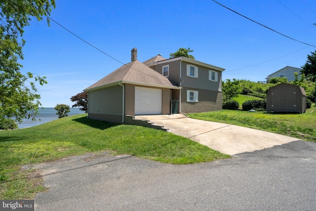 295 Chesapeake Ave, Prince Frederick, MD 20678 - view of front facade with driveway, a front yard, a garage, and a water view