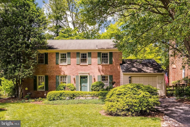 18919 Diary Rd, Montgomery Village, MD 20886 - colonial inspired home featuring an attached garage, a front lawn, brick siding, and driveway
