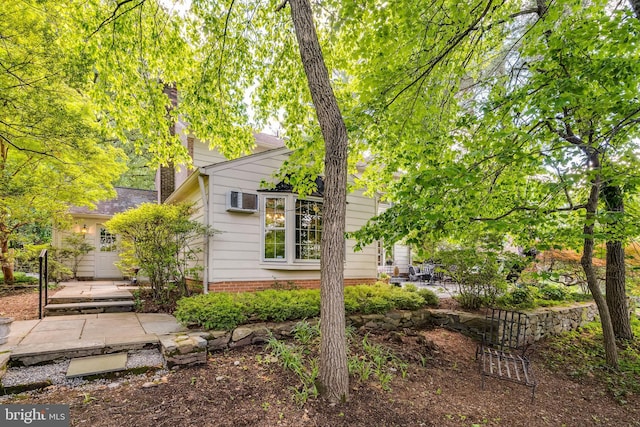18919 Diary Rd, Montgomery Village, MD 20886 - view of front of house with a patio, a chimney, and a wall mounted air conditioner