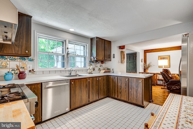 18919 Diary Rd, Montgomery Village, MD 20886 - kitchen featuring dishwasher, a sink, light countertops, a peninsula, and a textured ceiling