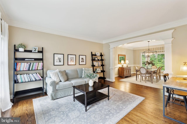13016 Brookmead Dr, Manassas, VA 20112 - living room featuring decorative columns, crown molding, wood finished floors, arched walkways, and a chandelier