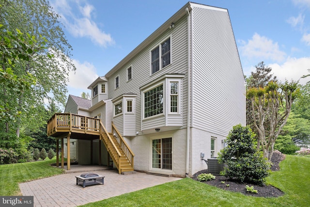 13016 Brookmead Dr, Manassas, VA 20112 - back of house featuring an outdoor fire pit, a patio, a wooden deck, a lawn, and stairs