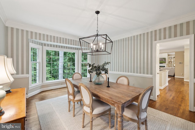 13016 Brookmead Dr, Manassas, VA 20112 - dining area with crown molding, wood finished floors, a chandelier, wallpapered walls, and baseboards