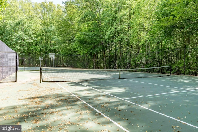 13016 Brookmead Dr, Manassas, VA 20112 - view of tennis court featuring a forest view