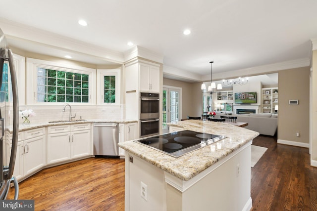 13016 Brookmead Dr, Manassas, VA 20112 - kitchen with stainless steel appliances, a center island, ornamental molding, wood finished floors, and a sink
