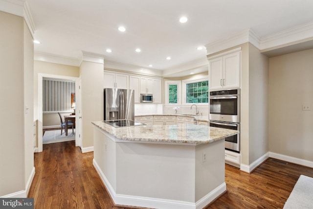 13016 Brookmead Dr, Manassas, VA 20112 - kitchen featuring appliances with stainless steel finishes, crown molding, a kitchen island, tasteful backsplash, and dark wood-style flooring