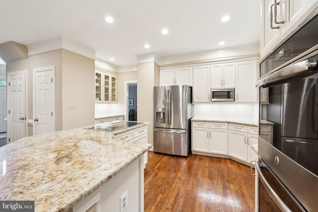 13016 Brookmead Dr, Manassas, VA 20112 - kitchen featuring appliances with stainless steel finishes, ornamental molding, light stone counters, glass insert cabinets, and white cabinetry