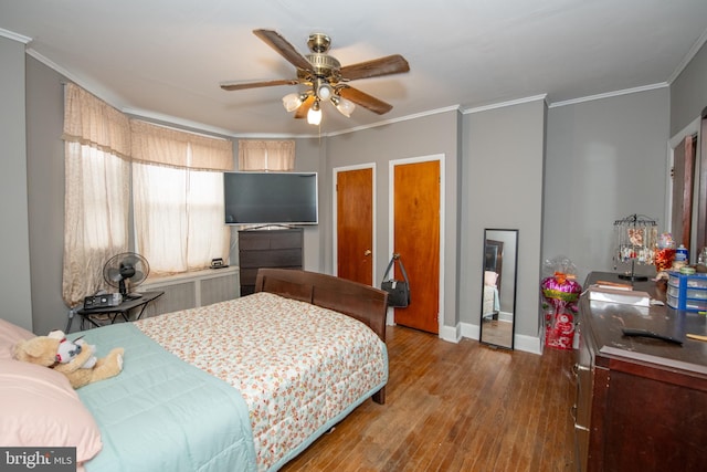 3444 G St, Philadelphia, PA 19134 - bedroom featuring ornamental molding, wood finished floors, baseboards, a ceiling fan, and multiple closets