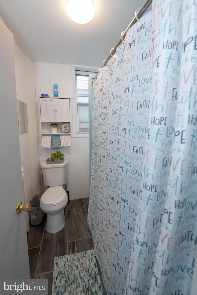 3444 G St, Philadelphia, PA 19134 - bathroom featuring toilet, wood finish floors, and a shower with shower curtain