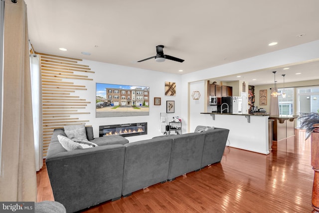3536 Pipestone Pl, Waldorf, MD 20601 - living room featuring wood finished floors, a glass covered fireplace, a ceiling fan, and recessed lighting