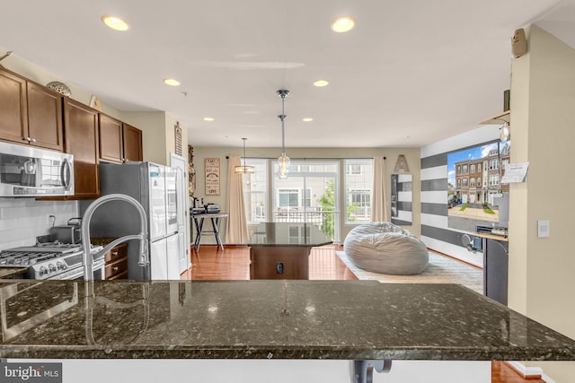 3536 Pipestone Pl, Waldorf, MD 20601 - kitchen with stainless steel appliances, backsplash, recessed lighting, dark stone counters, and a center island