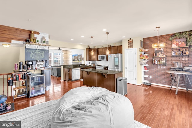 3536 Pipestone Pl, Waldorf, MD 20601 - kitchen with appliances with stainless steel finishes, open floor plan, dark wood finished floors, a center island, and pendant lighting
