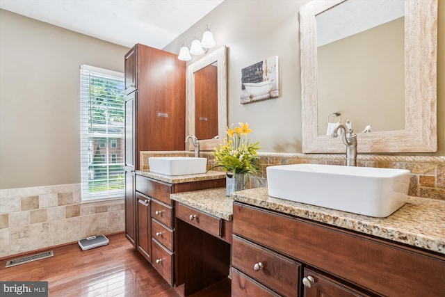 16719 Tintagel Ct, Dumfries, VA 22025 - bathroom with tile walls, double vanity, wainscoting, and wood finished floors