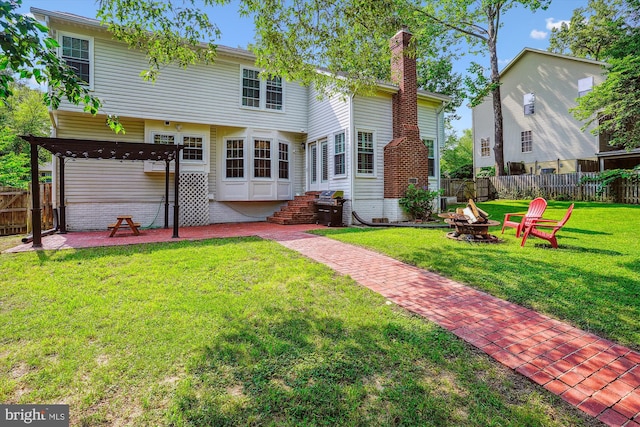 16719 Tintagel Ct, Dumfries, VA 22025 - rear view of property featuring a fire pit, a chimney, a patio, and entry steps