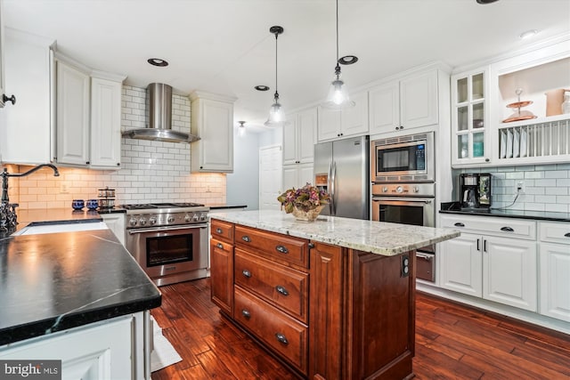 16719 Tintagel Ct, Dumfries, VA 22025 - kitchen with wall chimney range hood, appliances with stainless steel finishes, white cabinetry, tasteful backsplash, and dark wood-style floors