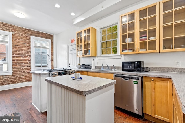 1328 35th St NW, Washington, DC 20007 - kitchen featuring dishwasher, black microwave, brick wall, dark wood-style floors, and a kitchen island