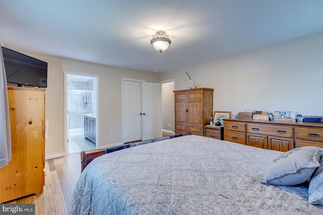 14298 S Union Church Rd, Ellendale, DE 19941 - bedroom with light wood finished floors, ensuite bathroom, and baseboards