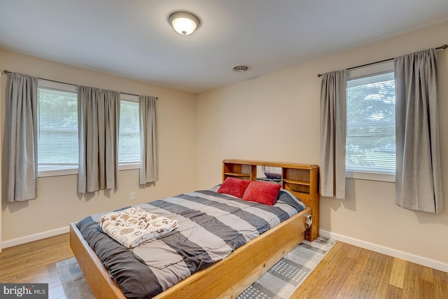 14298 S Union Church Rd, Ellendale, DE 19941 - bedroom featuring multiple windows, wood finished floors, and baseboards