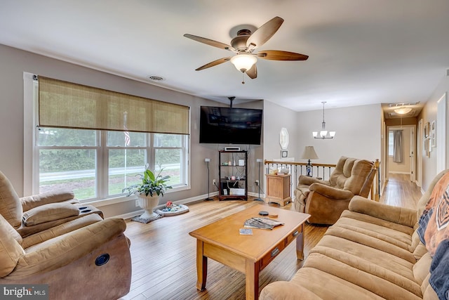 14298 S Union Church Rd, Ellendale, DE 19941 - living room with ceiling fan, wood finished floors, baseboards, and a chandelier