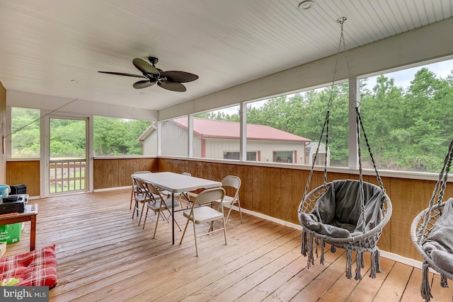 14298 S Union Church Rd, Ellendale, DE 19941 - sunroom / solarium featuring a wooden deck, a ceiling fan, hardwood / wood-style floors, outdoor dining space, and wood walls