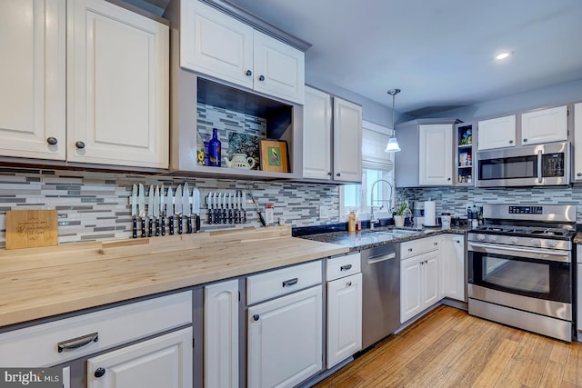 14298 S Union Church Rd, Ellendale, DE 19941 - kitchen featuring appliances with stainless steel finishes, open shelves, a sink, white cabinetry, and recessed lighting