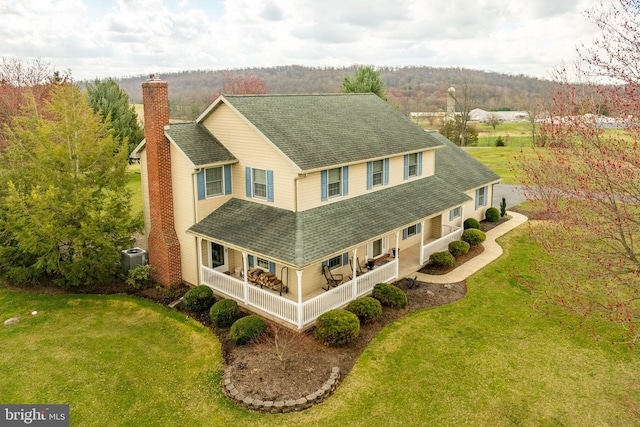 290 S Windy Mansion Rd, Denver, PA 17517 - view of front of house featuring a chimney, a shingled roof, a porch, and a front yard
