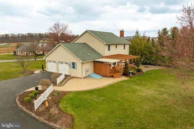 290 S Windy Mansion Rd, Denver, PA 17517 - rear view of house featuring driveway, roof with shingles, a yard, a deck, and an attached garage