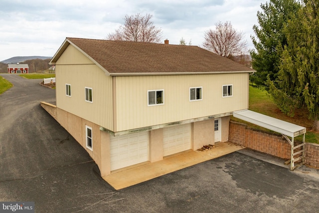 290 S Windy Mansion Rd, Denver, PA 17517 - view of home's exterior featuring asphalt driveway, a shingled roof, and a garage