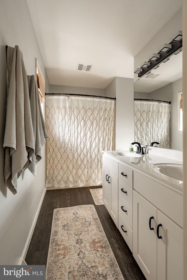 290 S Windy Mansion Rd, Denver, PA 17517 - bathroom with double vanity, wood finished floors, and baseboards