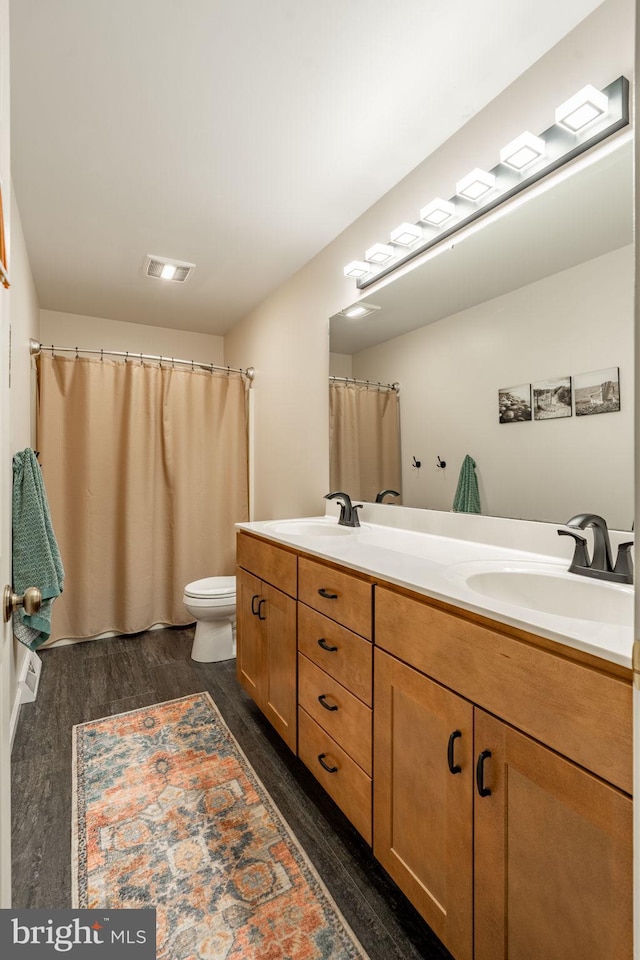 290 S Windy Mansion Rd, Denver, PA 17517 - full bathroom with double vanity, wood finished floors, toilet, and curtained shower