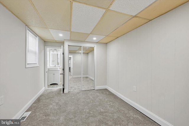 406 S Eaton St, Baltimore, MD 21224 - unfurnished bedroom featuring carpet, a closet, a paneled ceiling, ensuite bath, and baseboards