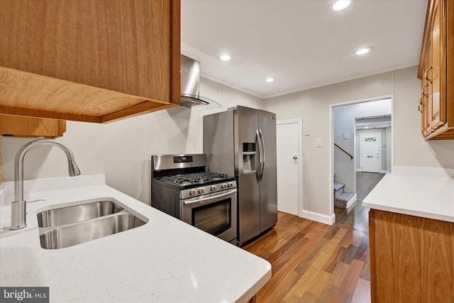 406 S Eaton St, Baltimore, MD 21224 - kitchen with appliances with stainless steel finishes, a sink, wall chimney exhaust hood, light countertops, and brown cabinets