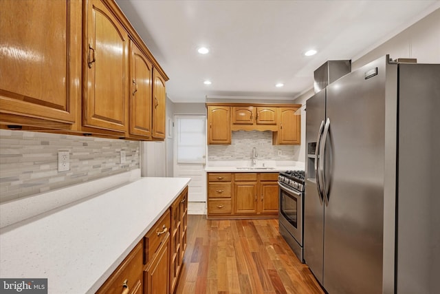 406 S Eaton St, Baltimore, MD 21224 - kitchen with stainless steel appliances, wood finished floors, backsplash, a sink, and recessed lighting