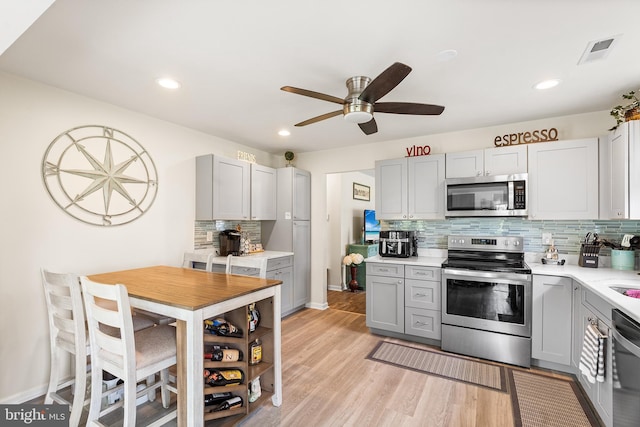 9 Peppergrass Dr N, Mount Laurel, NJ 08054 - kitchen with appliances with stainless steel finishes, gray cabinets, a ceiling fan, tasteful backsplash, and light countertops