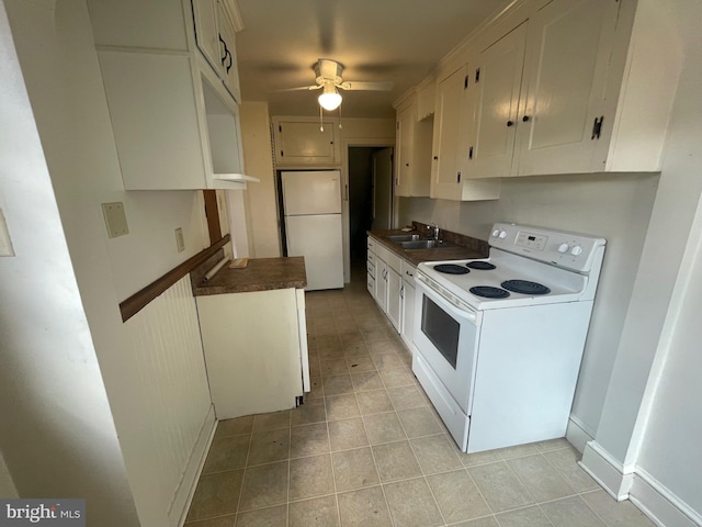 kitchen with white appliances, light tile patterned flooring, a sink, white cabinets, and a ceiling fan