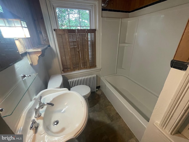 bathroom with radiator, healthy amount of natural light, toilet, and a sink