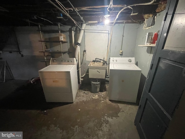 unfinished basement featuring a sink and separate washer and dryer